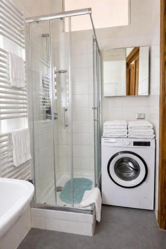 a bathroom with a shower and a washing machine at Al Piccolo Cassaro in Caltanissetta