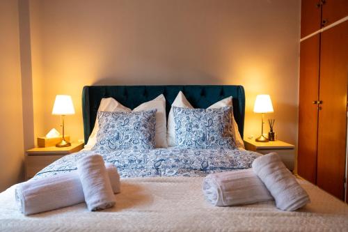 a bedroom with a bed with two pillows on it at Central Boutique Apartment Gythio in Gythio