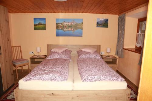 a bedroom with two beds and two tables at Ferienhaus Stockmeier in Otting