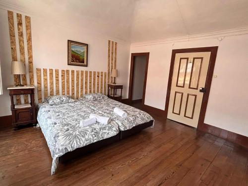 a bedroom with a bed with two books on it at Esposende Garden in Esposende