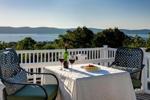 a table with two chairs and a bottle of wine at Tarrytown House Estate in Tarrytown