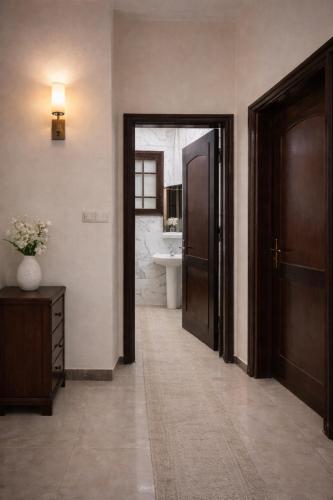 a hallway with a bathroom with a toilet and a sink at Luxor flats and apartments in Luxor