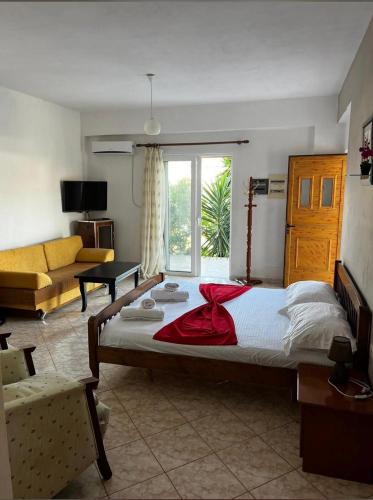 a bedroom with a large bed and a couch at VIOLA Seaside Villa in Ksamil