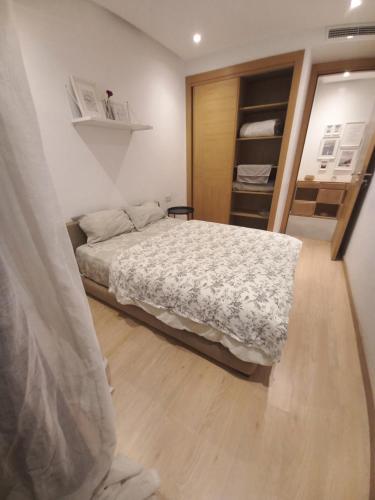 a small bedroom with a bed and a closet at Princess Mayfer in Maarif