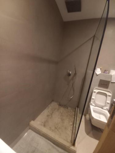 a small bathroom with a toilet and a shower at Princess Mayfer in Maarif
