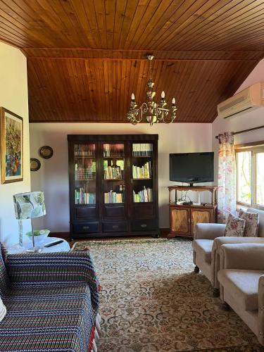 a living room with a couch and a chandelier at Quinta de Carcavelos Agroturismo e Enoturismo in Celorico de Basto