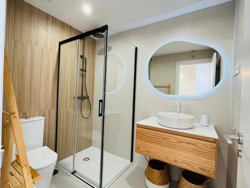 a bathroom with a sink and a mirror at RÍA LIVING - Arena 01 in Cee