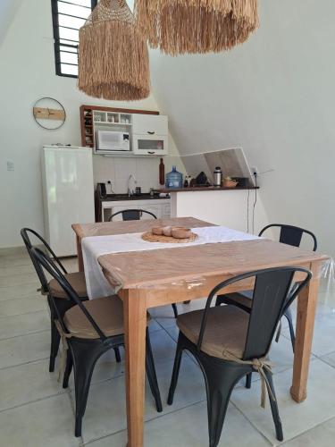 a kitchen with a wooden table and chairs at Estrellita Mia in Villa Ciudad Parque