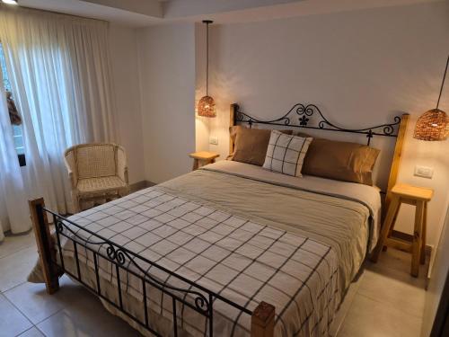 a bedroom with a large bed and two lamps at Estrellita Mia in Villa Ciudad Parque