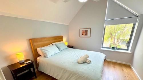 a bedroom with a large bed with a window at SixtySix at Cape View in Broadwater