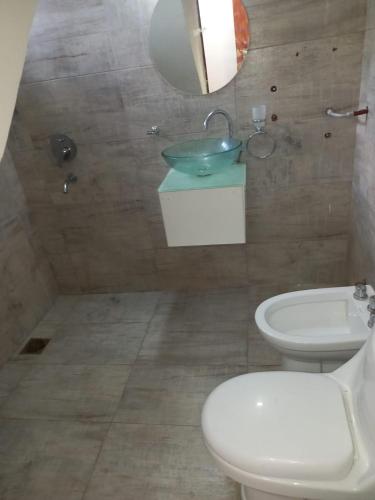 a bathroom with a white toilet and a sink at Solanas tanti in Tanti