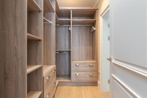a walk in closet with wooden cabinets at Derwent Lodge in Dublin