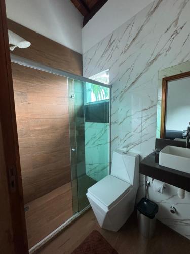 a bathroom with a shower and a toilet and a sink at Flat Bluvi Centro de Barra-Grande in Marau