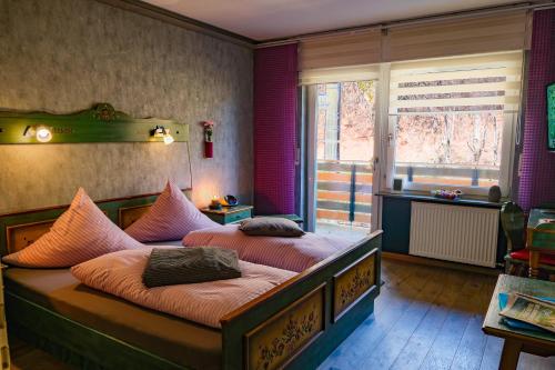 a bedroom with two beds and a window at Pension Pulvermühle in Waischenfeld