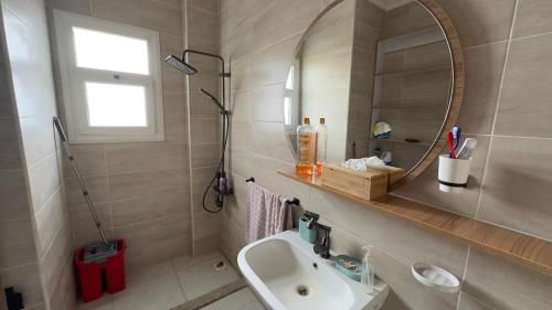 a bathroom with a sink and a mirror at Boho sokhna families only in Ain Sokhna