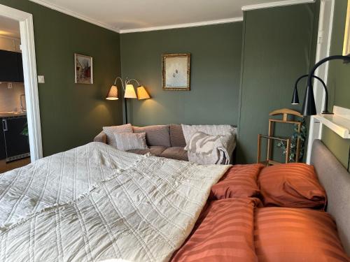 a bedroom with a bed and a couch at Stora Torget B&B in Eksjö