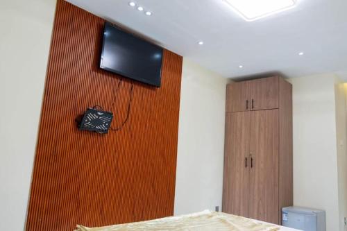 a bedroom with a flat screen tv on a wall at Résidence Madior D1 in Dakar