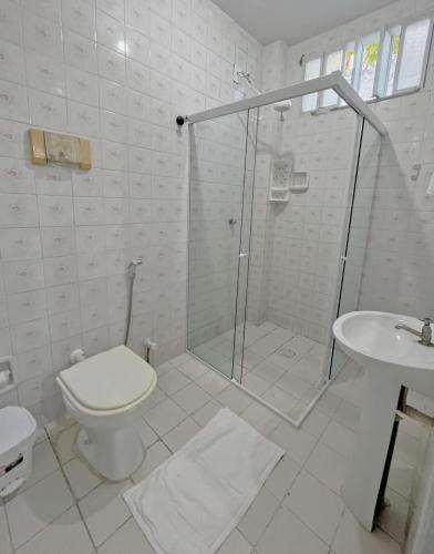 a bathroom with a shower and a toilet and a sink at Pousada Valmar in Aracaju