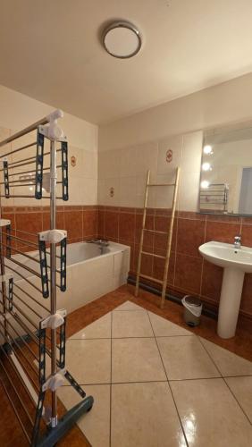 a bathroom with a bath tub and a sink at Le haie vigné in Caen