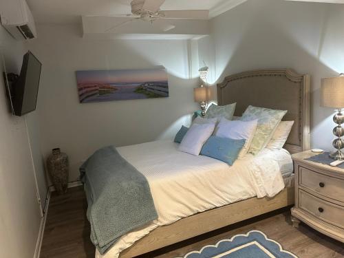a bedroom with a bed with blue and white pillows at 2 bedroom Apt in long branch in Long Branch