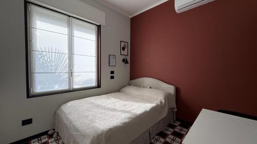a small bedroom with a bed and a window at Design studio Margherita in Cinisello Balsamo