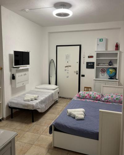 a hospital room with two beds and a tv at Virgy’s House in Sestu