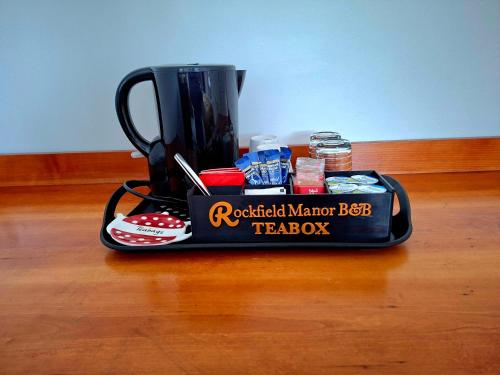 a black coffee maker sitting on top of a table at Rockfield Manor B&B, Knock in Knock