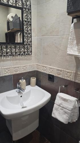 a bathroom with a white sink and a mirror at Hostal La Garita in Peniscola