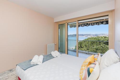 a bedroom with two beds and a large window at Rives dor4B in Juan-les-Pins
