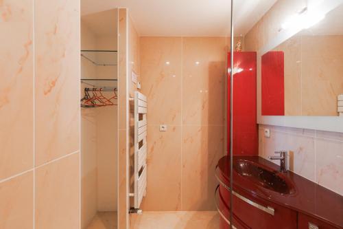 a bathroom with a red sink and a glass shower at Rives dor4B in Juan-les-Pins