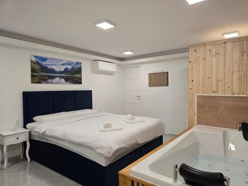 a bedroom with a bed and a bath tub at Jacuzzi & Sauna Edy room - city center in Zagreb