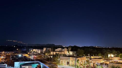a view of a city at night at Happy House in Al Ain