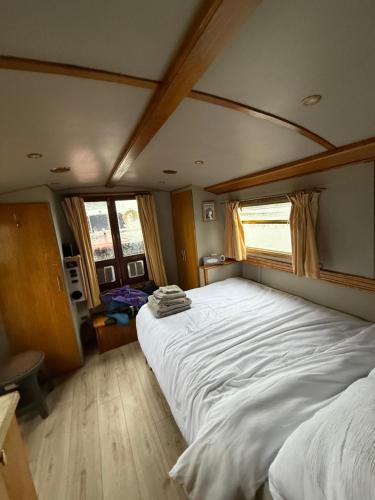 a bedroom with a large white bed with a window at The Erne Rambler in Silverhill