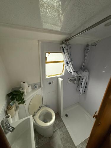 a small bathroom with a toilet and a window at The Erne Rambler in Silverhill