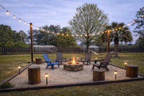 a fire pit with chairs and lights in a yard at Family Country Retreat w Pool, Games & Fire Pit in Clewiston