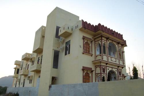 a building with many windows on the side of it at Hotel Green Haveli - A Heritage and Hill View Hotel , Pushkar in Pushkar