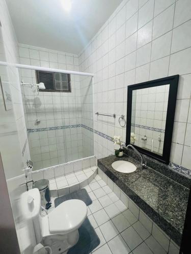 a bathroom with a toilet and a sink and a mirror at Allmedhouse in São Luís