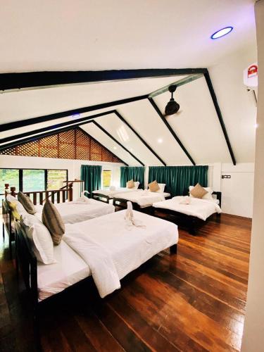 a room with four beds in a room with a ceiling at Bidaisari Resort in Kampong Sum Sum