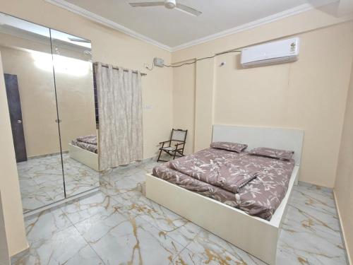 a bedroom with a bed and a mirror at Sakez Homestays HH in Hyderabad