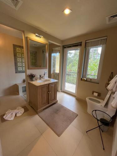 a bathroom with a sink and a toilet and a mirror at Binh An Village Resort in Da Lat