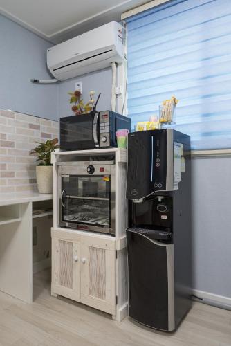 a kitchen with a microwave and a toaster oven at DreamTrip Guesthouse in Incheon