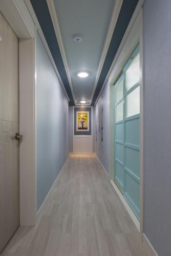 an empty hallway with a blue ceiling in a building at DreamTrip Guesthouse in Incheon
