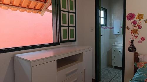 a bathroom with a counter and a window and a sink at Chalé da Ana in Ouro Preto