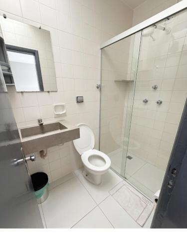 a bathroom with a shower and a toilet and a sink at Hotel Lords in Brasília