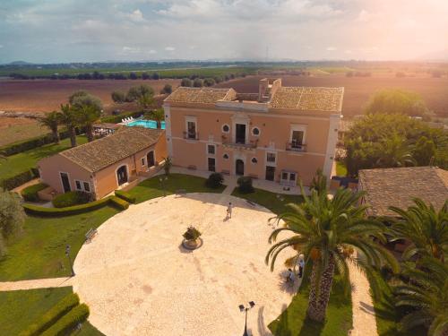 an aerial view of a large house with a palm tree at Hotel Lady Lusya in Syracuse