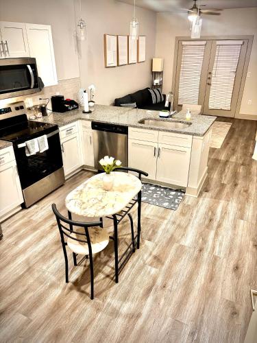 a kitchen with a table and chairs and a kitchen with a counter at New! 1 Bed 1 Bath Medical Center NRG Area Middle of Everywhere in Houston