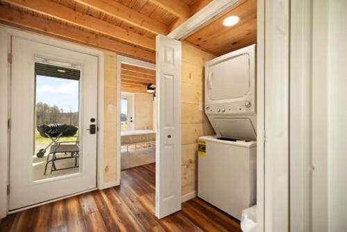 a tiny house with a kitchen and a balcony at Lake Cumberland Retreat in Faubush