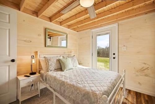 a bedroom with a bed and a mirror and a window at Lake Cumberland Retreat in Faubush