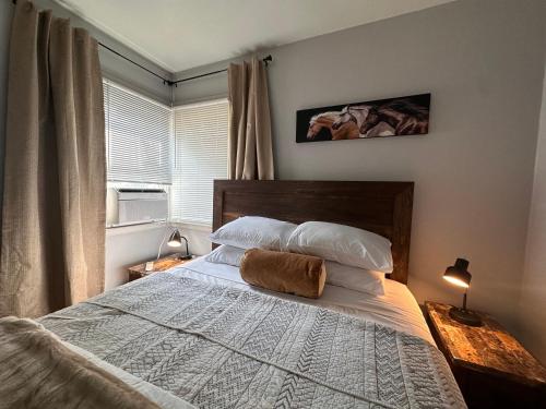 a bedroom with a bed with a pillow on it at Pets Welcome Walkable Downtown Apt Gym & Pool Pass in Sheridan