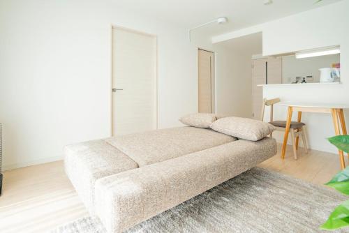 a living room with a couch and a table at La Meridian Atsubetsu 401 in Sapporo